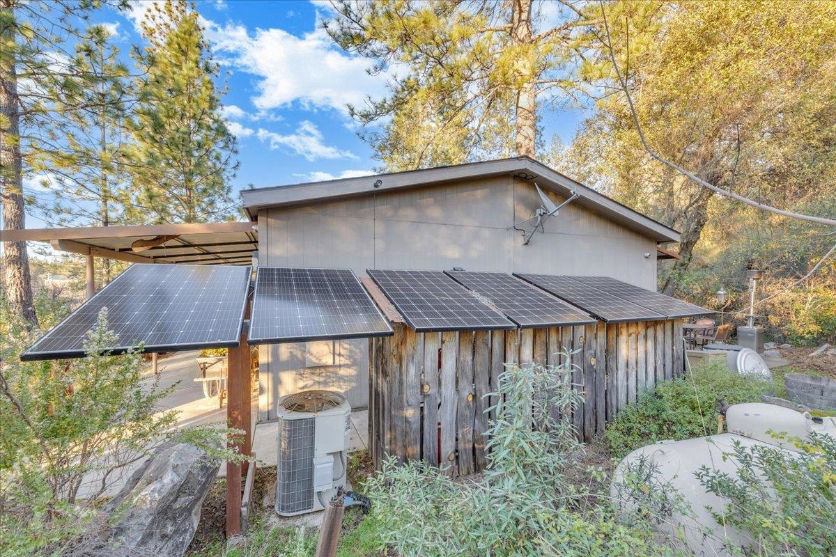 22389 Parrotts Ferry Road Columbia, CA 95310 - Photo 26 of 60 View of side of property featuring solar panels and a cooling unit