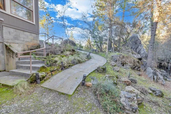 a living room with fireplace furniture and a chandelier