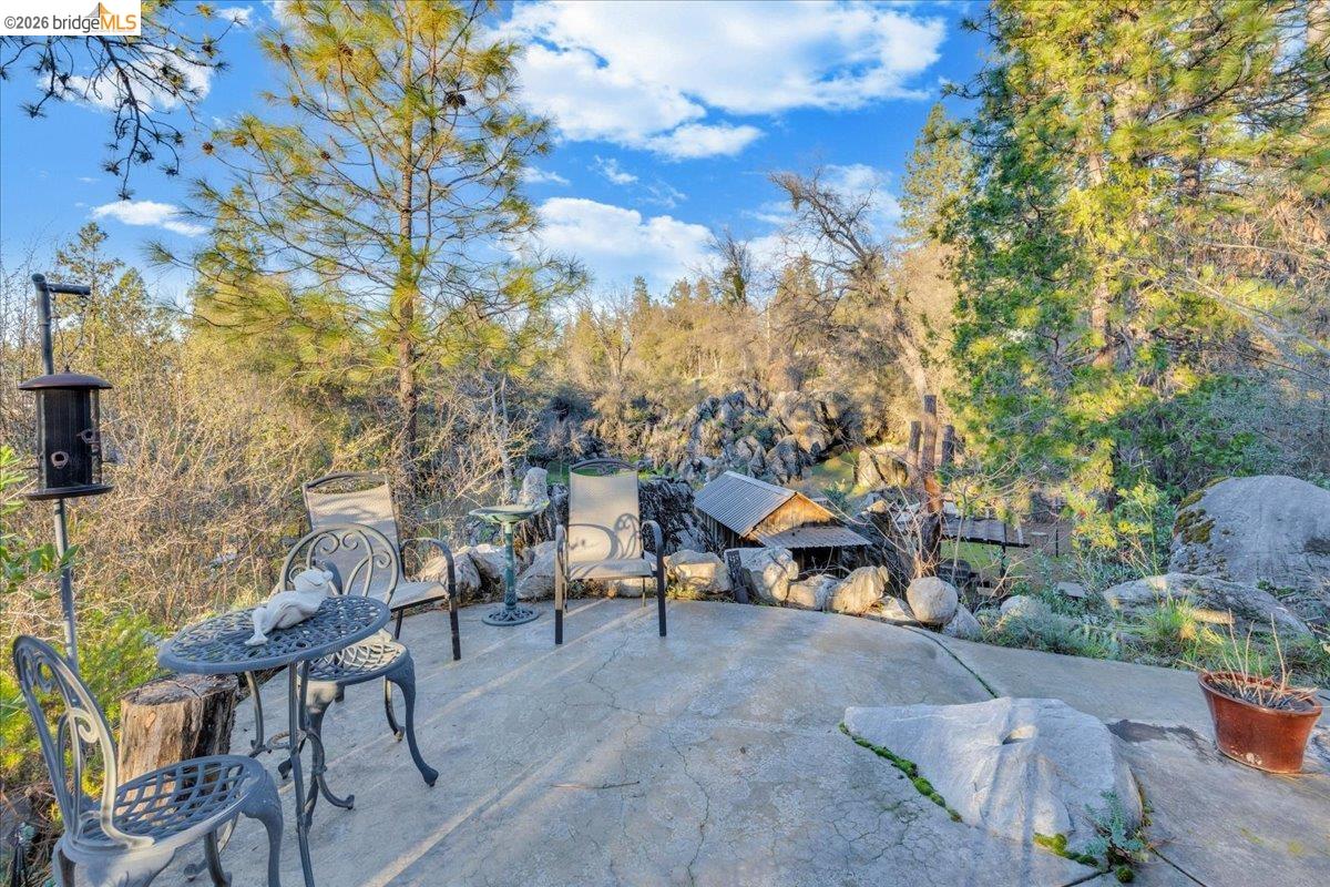 22389 Parrotts Ferry Road Columbia, CA 95310 - Photo 35 of 60 a view of a tables and chairs in a backyard