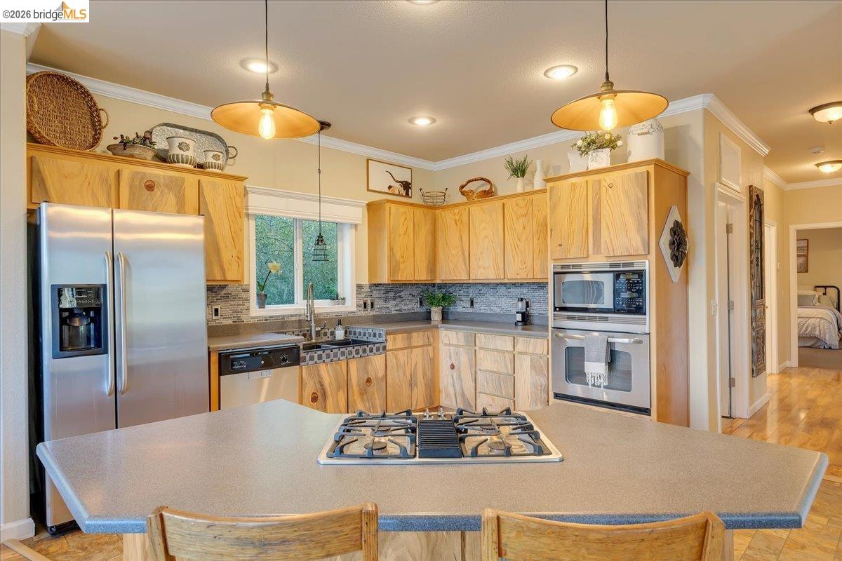 22389 Parrotts Ferry Road Columbia, CA 95310 - Photo 44 of 60 a kitchen with a refrigerator a stove a sink and white cabinets
