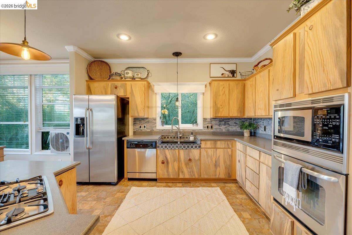 22389 Parrotts Ferry Road Columbia, CA 95310 - Photo 45 of 60 a kitchen with stainless steel appliances granite countertop a stove a sink and a refrigerator