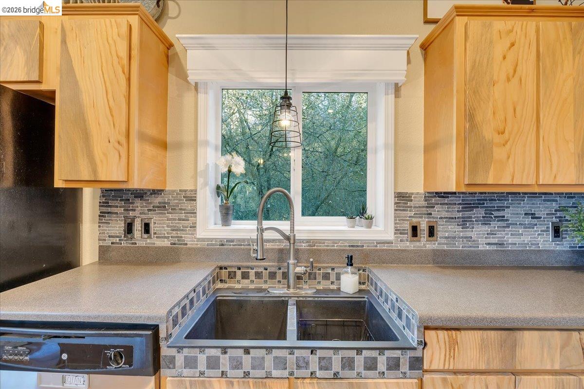 22389 Parrotts Ferry Road Columbia, CA 95310 - Photo 46 of 60 a kitchen with a sink a counter top space and cabinets