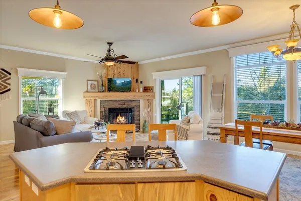 a spacious bedroom with a large bed and a chandelier fan