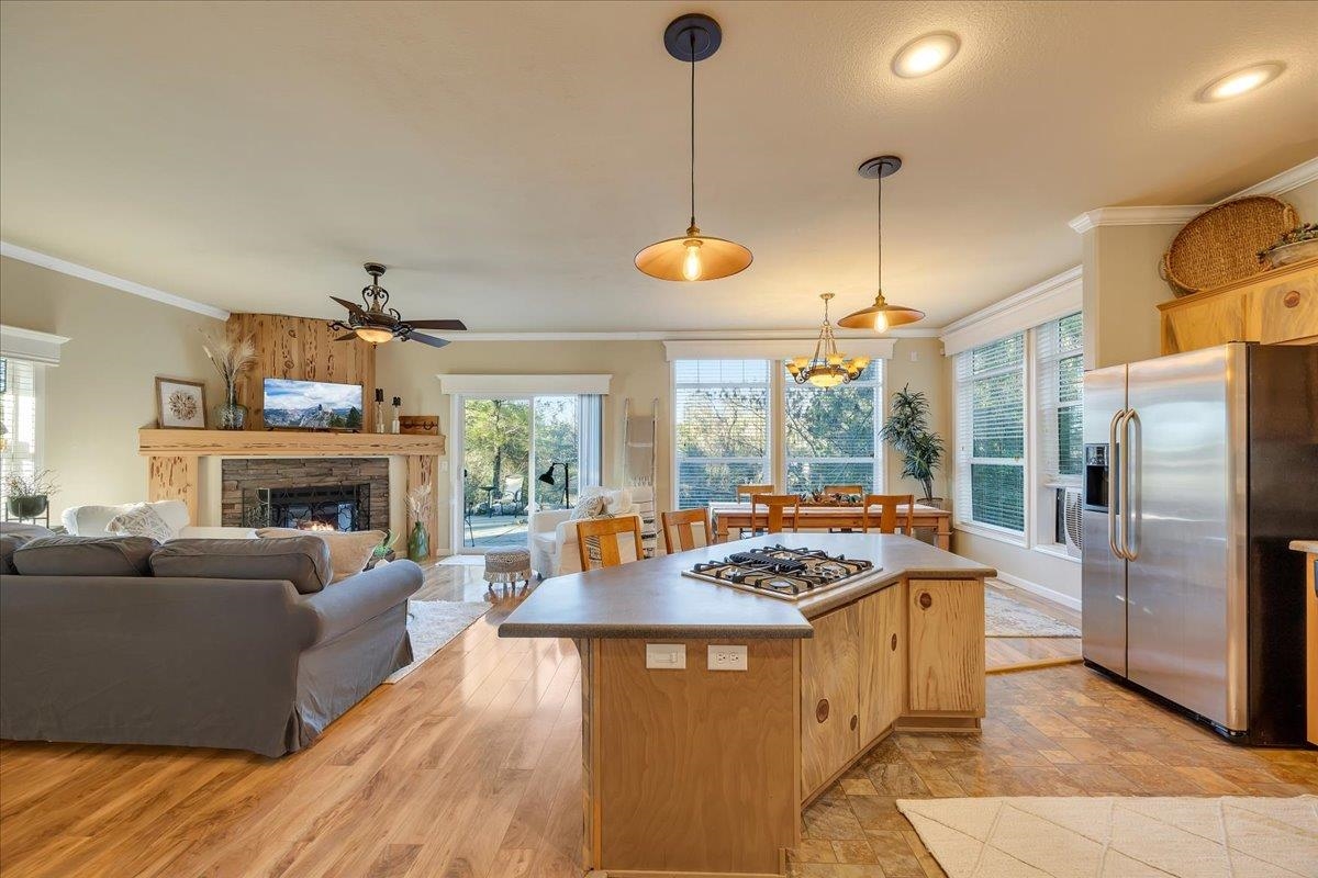 22389 Parrotts Ferry Road Columbia, CA 95310 - Photo 49 of 60 Kitchen with crown molding, appliances with stainless steel finishes, a center island, decorative light fixtures, and healthy amount of natural light
