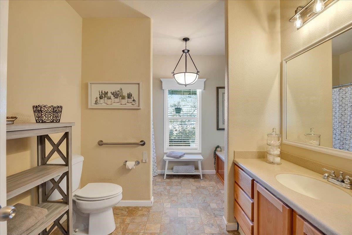 22389 Parrotts Ferry Road Columbia, CA 95310 - Photo 57 of 60 Full bath featuring vanity, stone finish flooring, and a shower with shower curtain