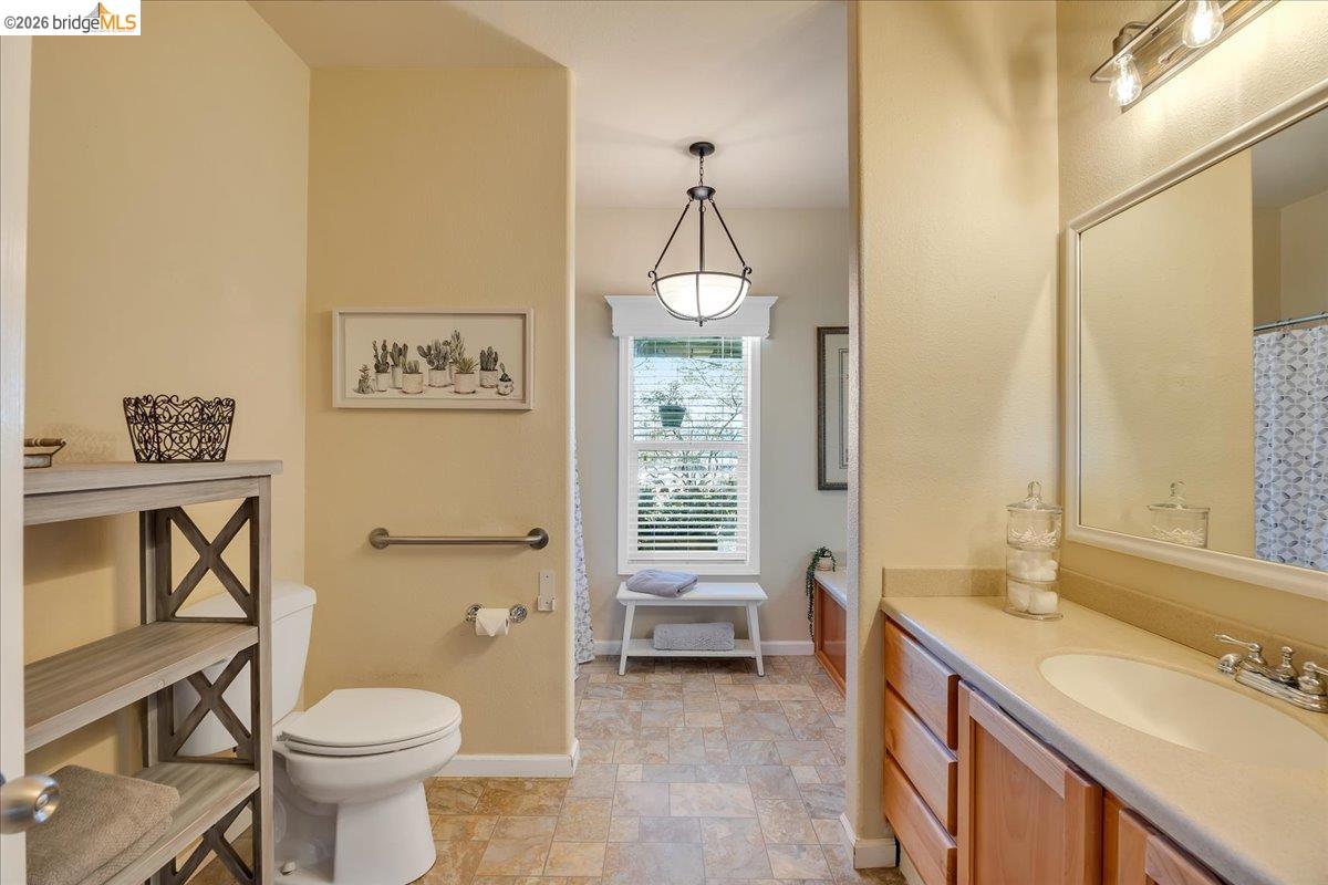 22389 Parrotts Ferry Road Columbia, CA 95310 - Photo 57 of 60 a bathroom with a toilet sink and mirror