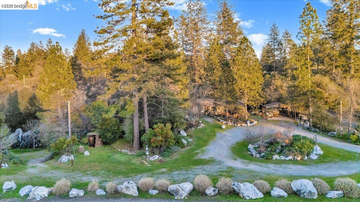 22389 Parrotts Ferry Road Columbia, CA 95310 - Photo 6 of 60 View of home's community with a lawn, a gazebo, and dirt driveway