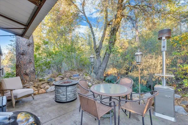 a table and chairs and a fire pit in the patio