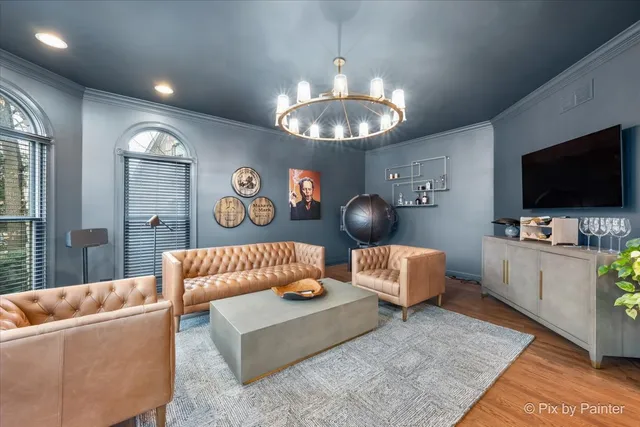 a living room with furniture a fireplace and a floor to ceiling window