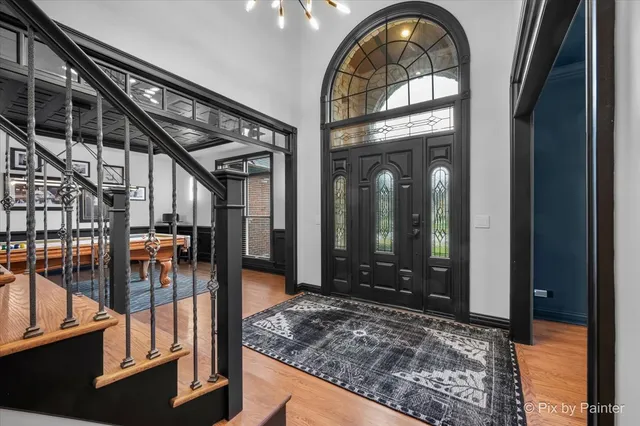 a view of entryway and hall with wooden floor