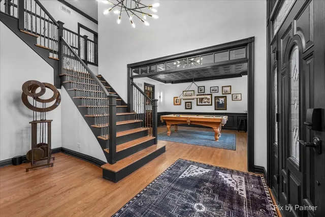 a view of staircase with a rug and a chandelier