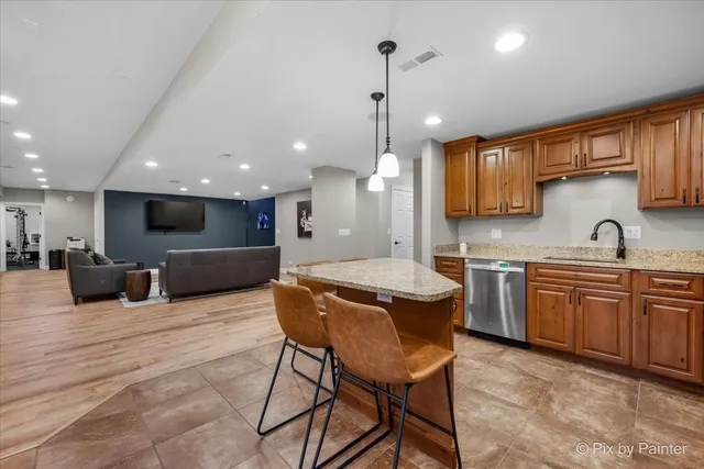 a view of a patio with couches chairs and wooden floor