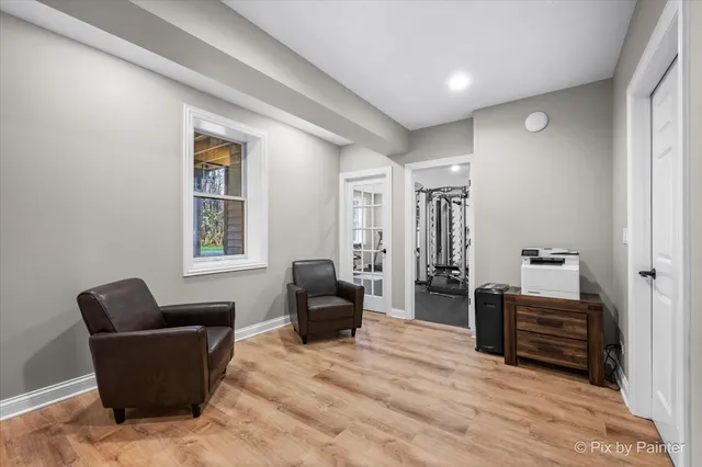 a white house with a large tree in front of it