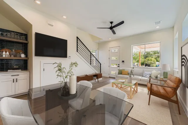 a living room with furniture a flat screen tv and a window