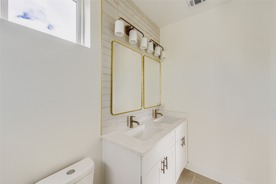 4712 South Forest Drive Austin, TX 78745 - Photo 21 of 27 a bathroom with a sink a toilet and a mirror