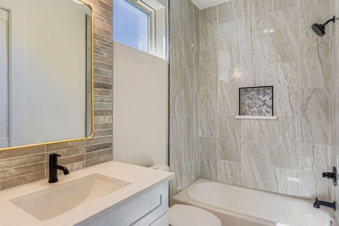 4712 South Forest Drive Austin, TX 78745 - Photo 24 of 27 a bathroom with a sink a toilet and shower