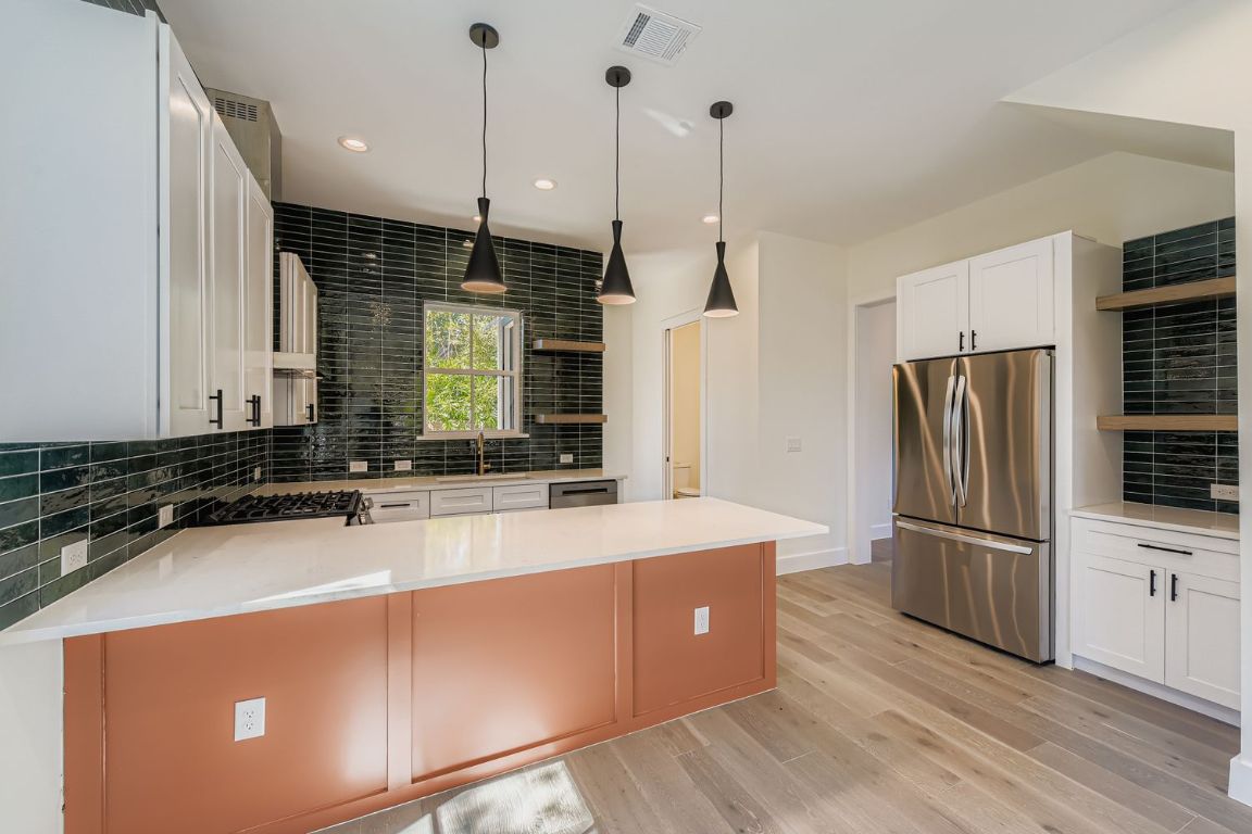 4712 South Forest Drive Austin, TX 78745 - Photo 10 of 27 a kitchen with stainless steel appliances granite countertop a refrigerator a sink and a stove