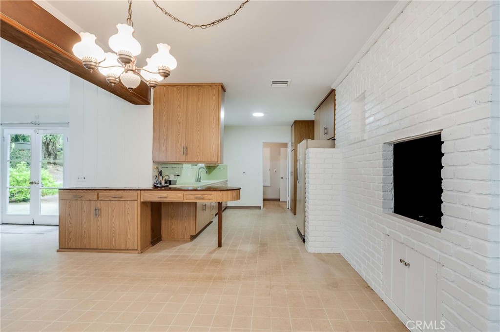 3665 Landfair Road Pasadena, CA 91107 - Photo 12 of 32 a bathroom with a sink a mirror and a chandelier