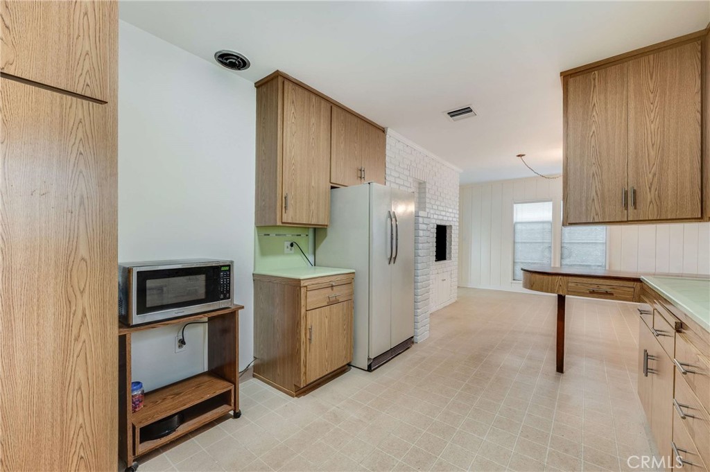 3665 Landfair Road Pasadena, CA 91107 - Photo 14 of 32 a kitchen with white cabinets and stainless steel appliances