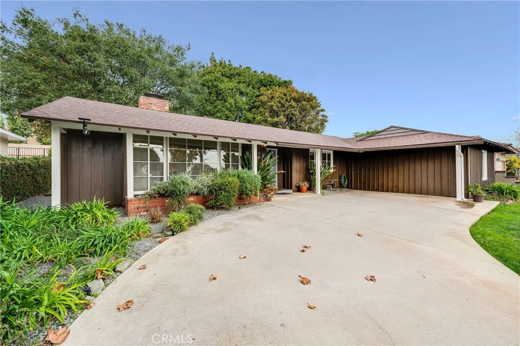 3665 Landfair Road Pasadena, CA 91107 - Photo 2 of 32 a view of a white house with a small yard plants and a large tree
