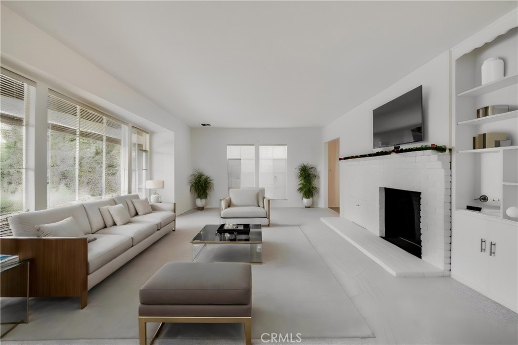 3665 Landfair Road Pasadena, CA 91107 - Photo 6 of 32 a living room with furniture a fireplace and a flat screen tv