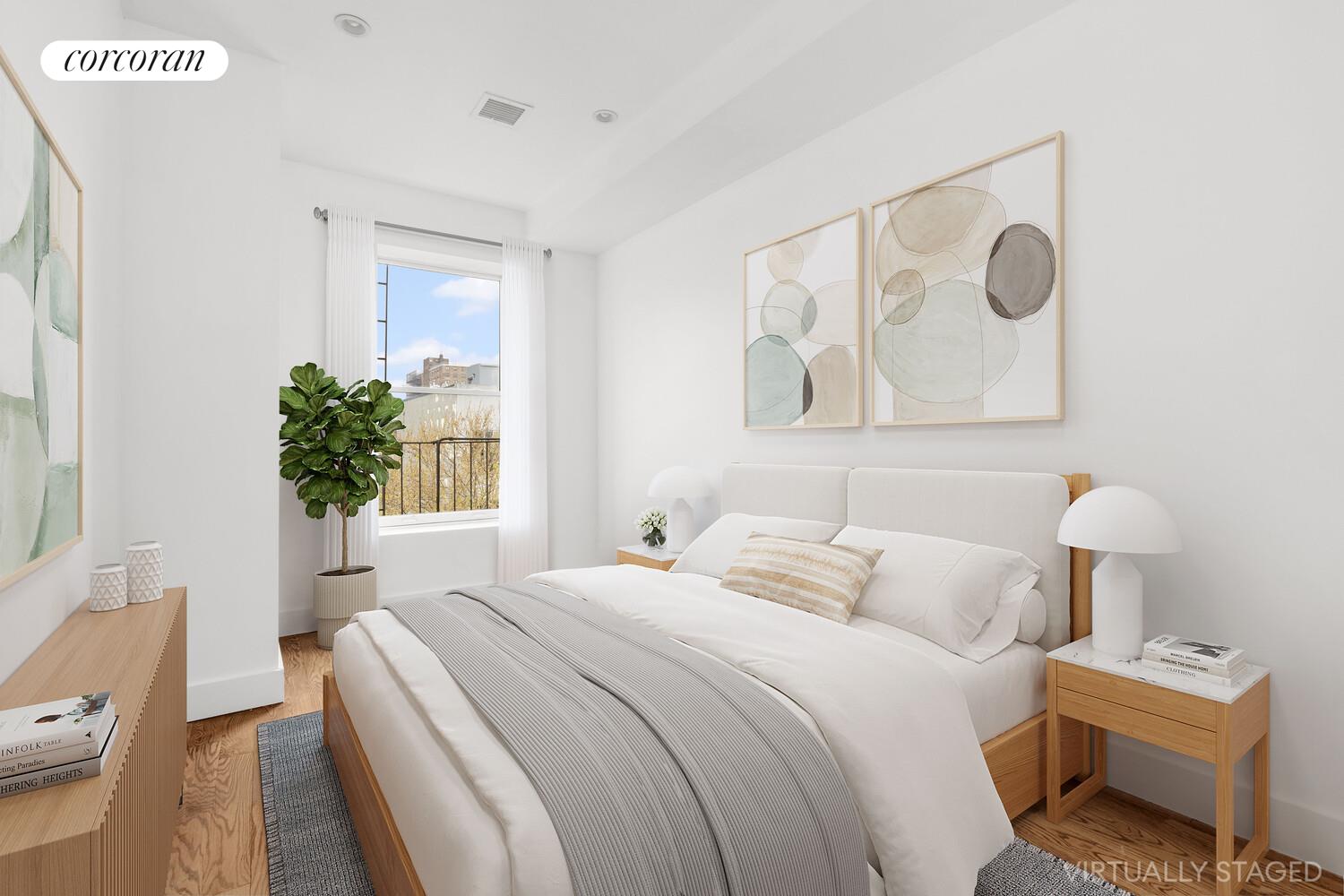 935 Lafayette Avenue, Unit 2 Brooklyn, NY 11221 - Photo 3 of 8 a bedroom with a bed and a potted plant