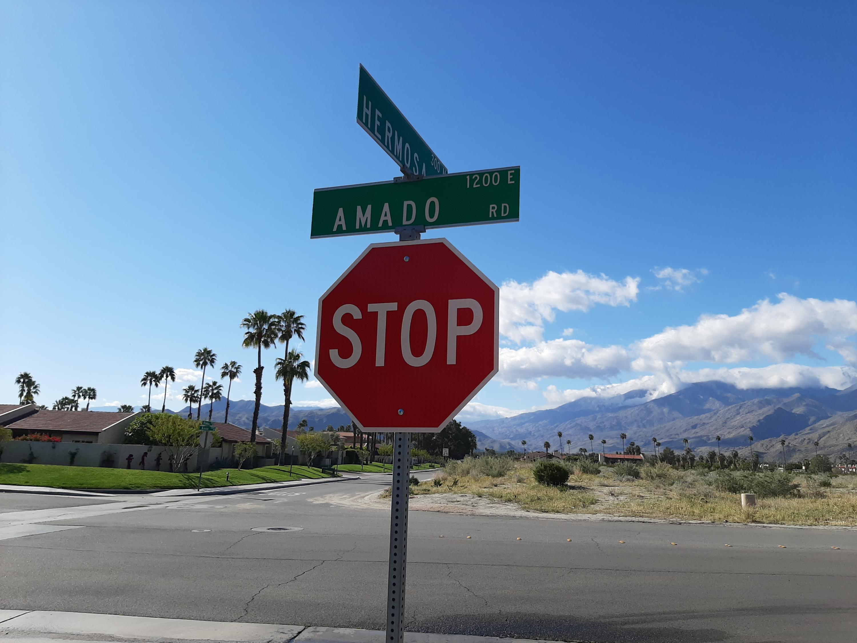 1150 East Amado Road, Unit 18D2 Palm Springs, CA 92262 - Photo 10 of 13 a sign that is on the side of the road