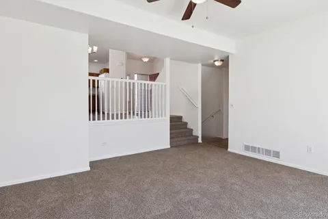 a view of an empty room with a ceiling fan