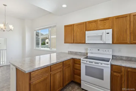 a kitchen with stainless steel appliances granite countertop a sink and a microwave