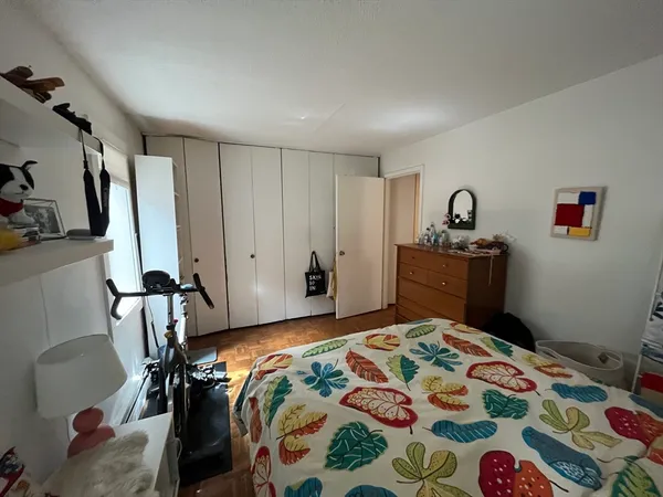 a bedroom with a bed and a dresser in it