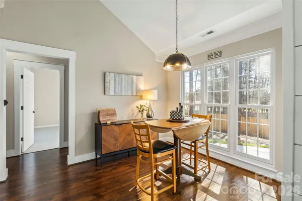 a view of a dining room with furniture window and wooden floor