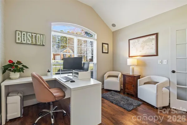 a view of a workspace with furniture and a window