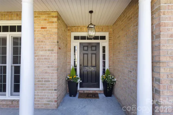 a front view of a building with potted plants