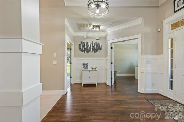 view of hall way with mirror and wooden floor