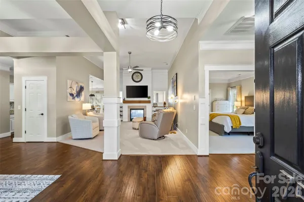 a living room with furniture and wooden floor