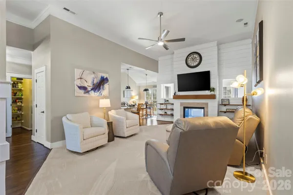 a living room with furniture a fireplace and a flat screen tv