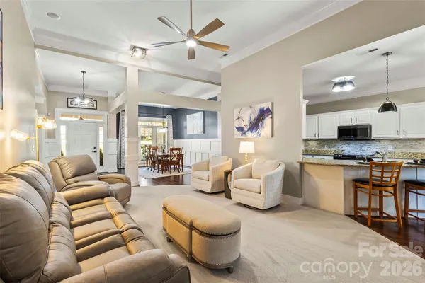 a living room with furniture and kitchen view