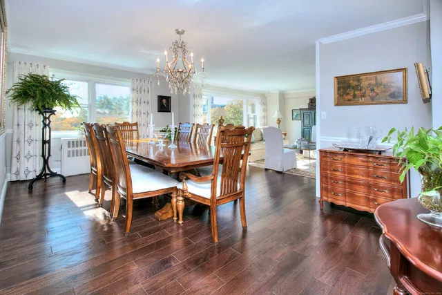 a dining room with furniture entryway and wooden floor