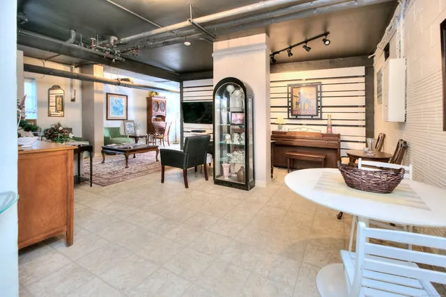a view of an empty room with furniture and a book shelf