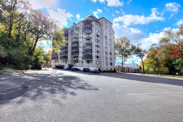 a view of a tall building next to a road