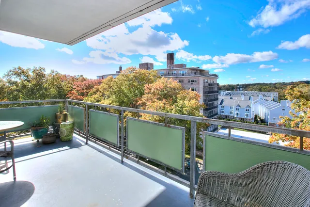 a view of a terrace with outdoor seating and city view