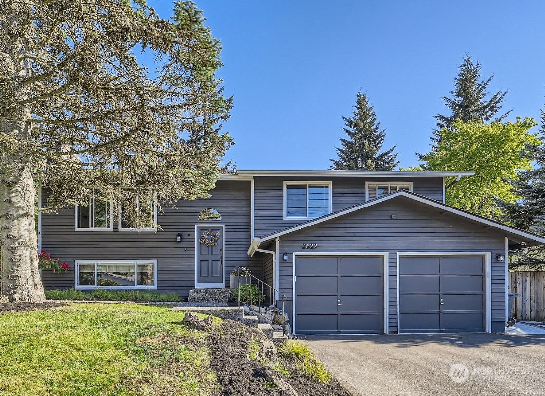 2622 168th Street Southeast Bothell, WA 98012 - Photo 1 of 29 a view of a yard in front of a house with a large tree