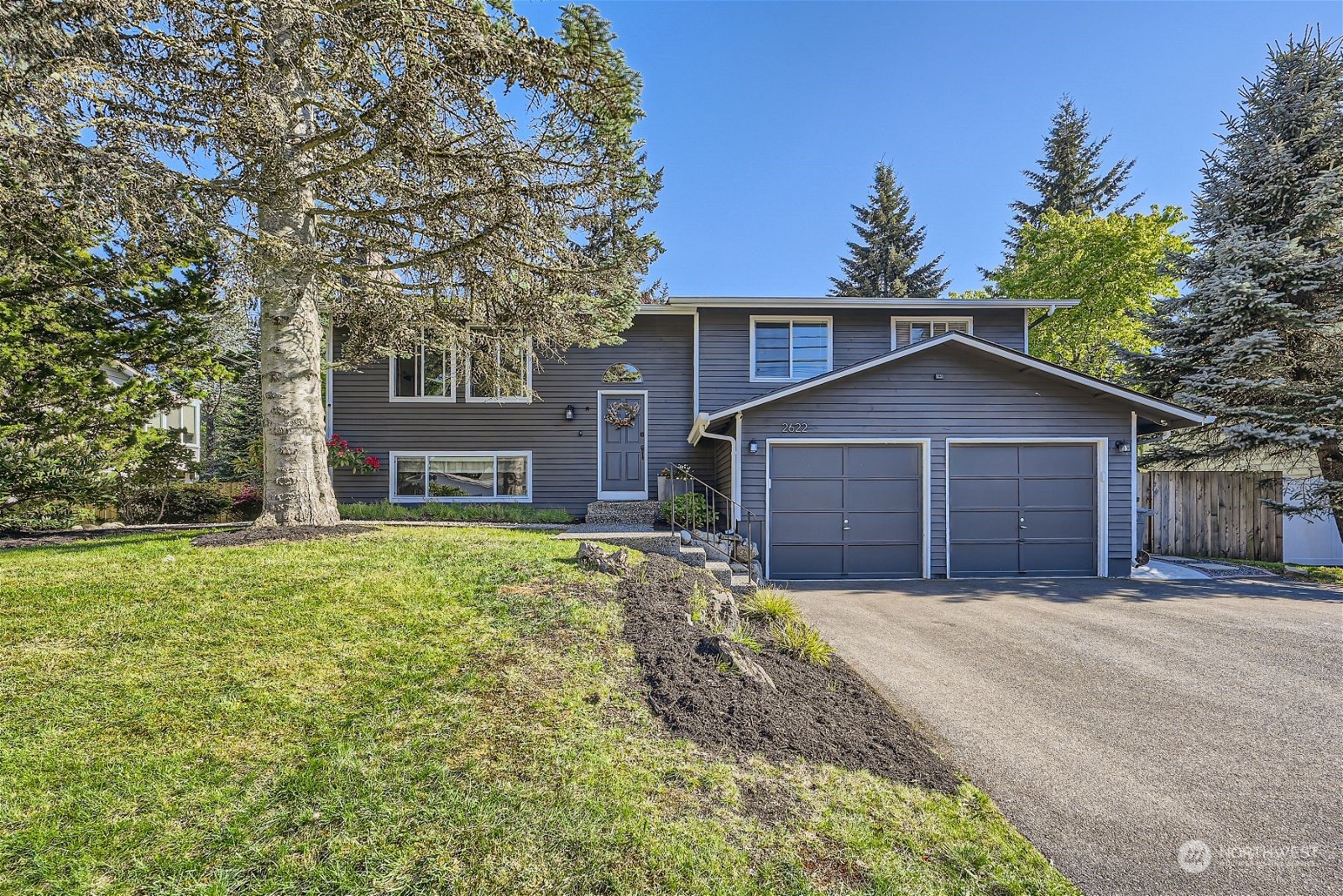 2622 168th Street Southeast Bothell, WA 98012 - Photo 2 of 29 a front view of a house with a yard and garage