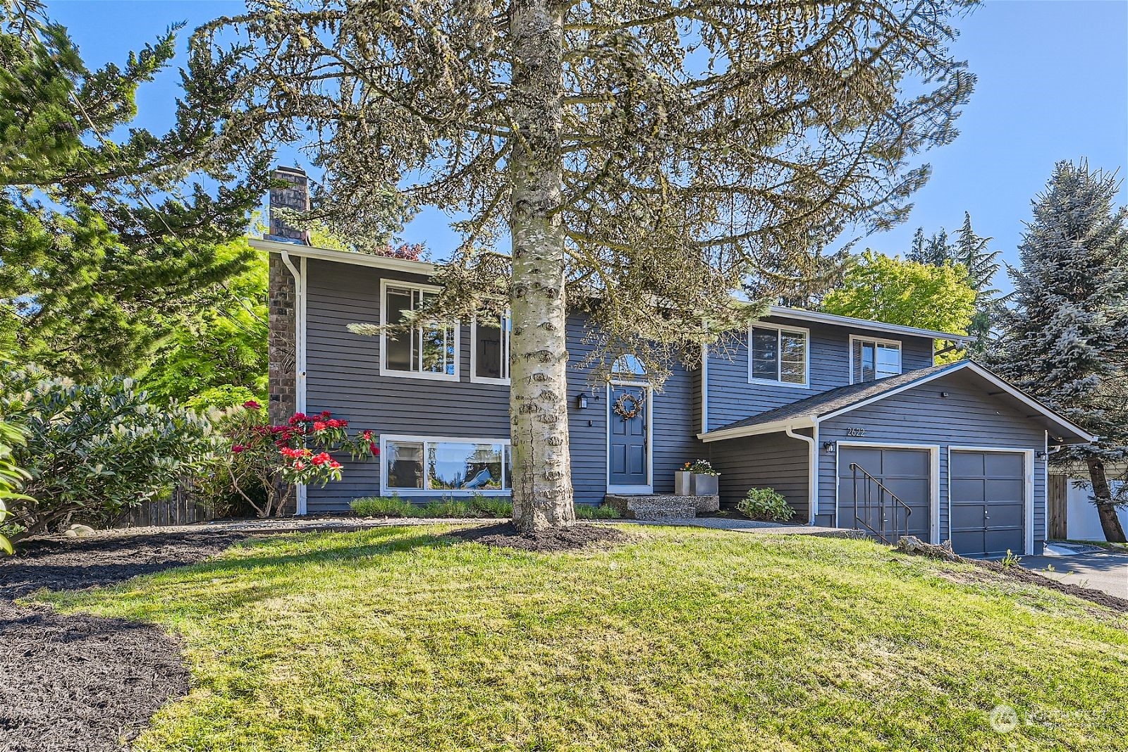 2622 168th Street Southeast Bothell, WA 98012 - Photo 3 of 29 a front view of a house with a yard
