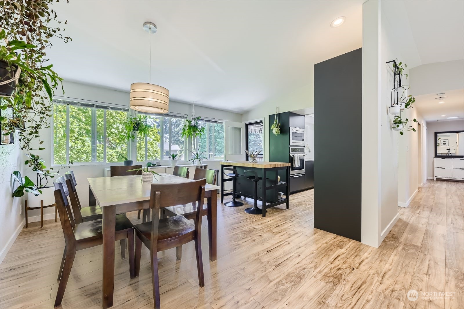 2622 168th Street Southeast Bothell, WA 98012 - Photo 7 of 29 a view of a dining room and livingroom with furniture wooden floor a chandelier