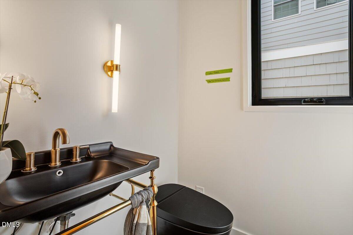 1213 Brookside Drive Raleigh, NC 27604 - Photo 11 of 50 a bathroom with a sink and a toilet