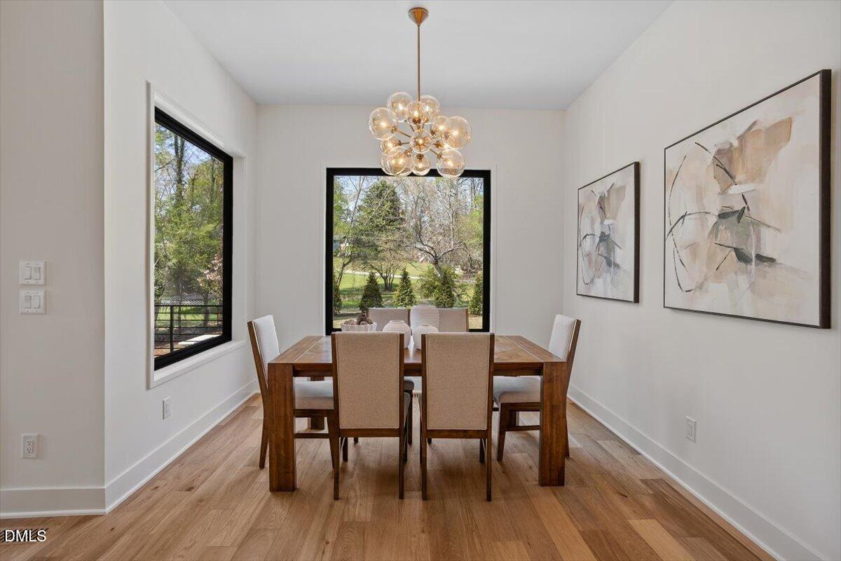 1213 Brookside Drive Raleigh, NC 27604 - Photo 23 of 50 a view of a dining room with furniture window and wooden floor