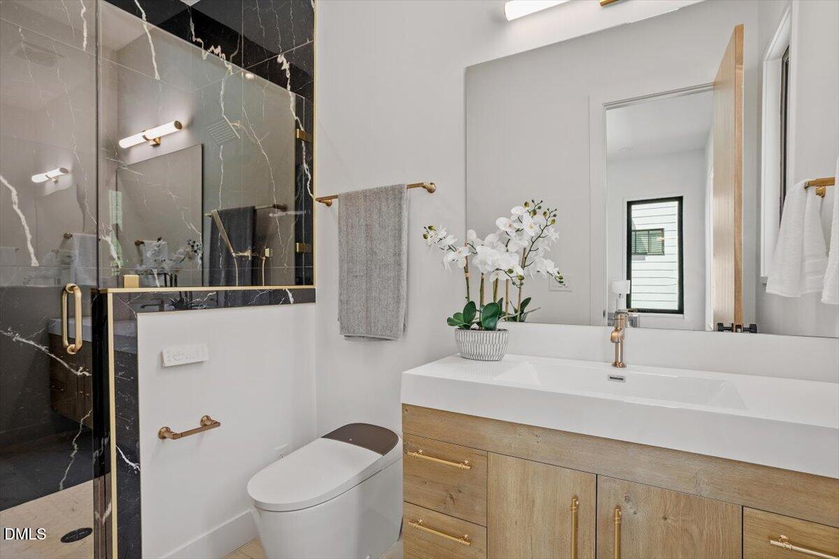 1213 Brookside Drive Raleigh, NC 27604 - Photo 29 of 50 a bathroom with a sink a toilet and a mirror