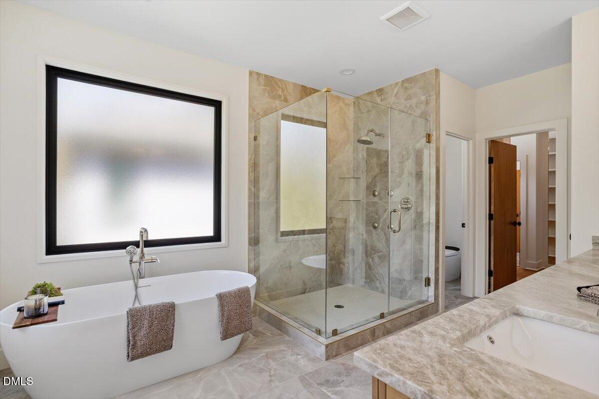1213 Brookside Drive Raleigh, NC 27604 - Photo 33 of 50 a bathroom with a shower sink and mirror