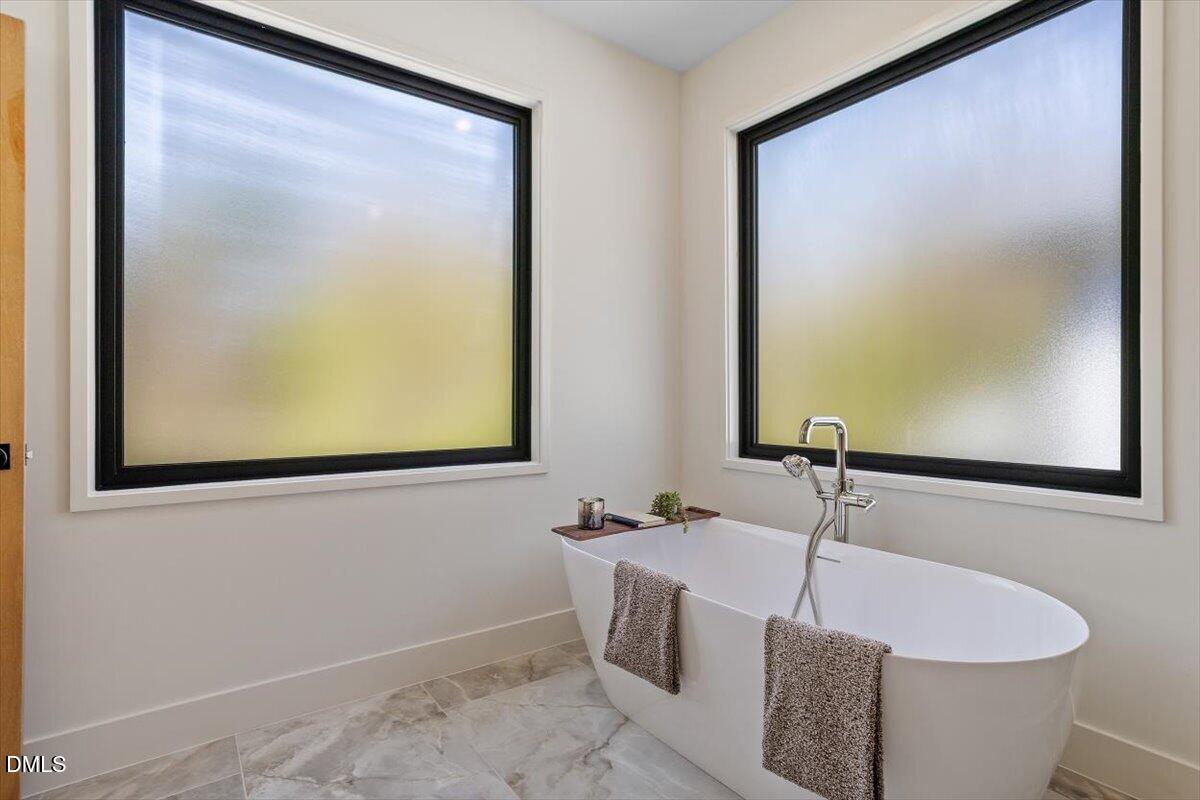 1213 Brookside Drive Raleigh, NC 27604 - Photo 34 of 50 a bathroom with a tub and a sink